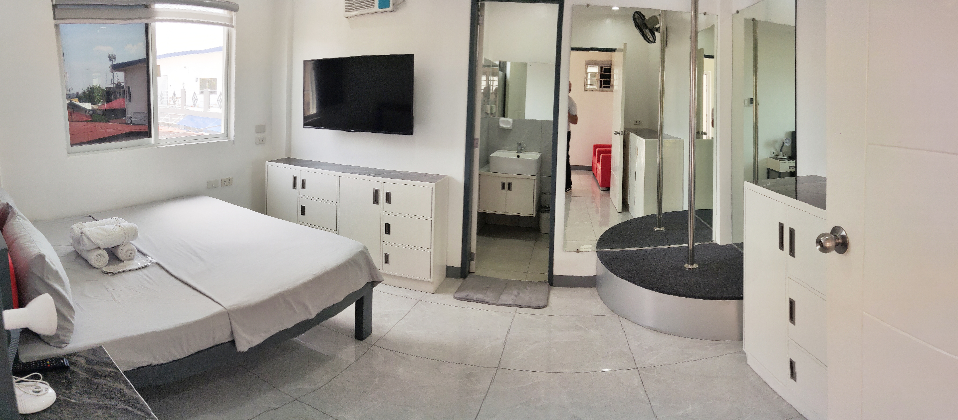 Doctor A CondoSuites wide bedroom view with feature platform and mirrors