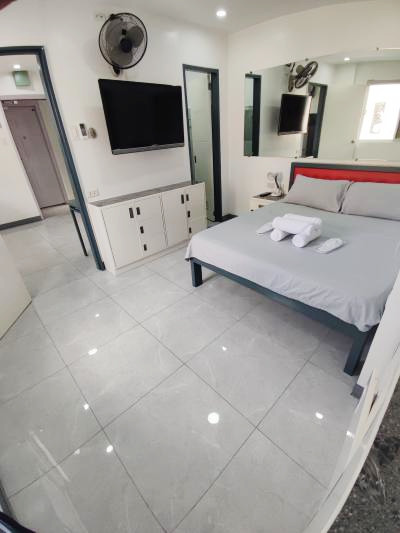 Doctor A CondoSuites furnished suite interior with bed and television