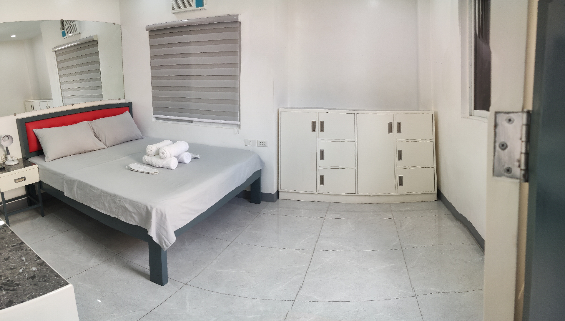 Doctor A CondoSuites bedroom with queen bed and storage